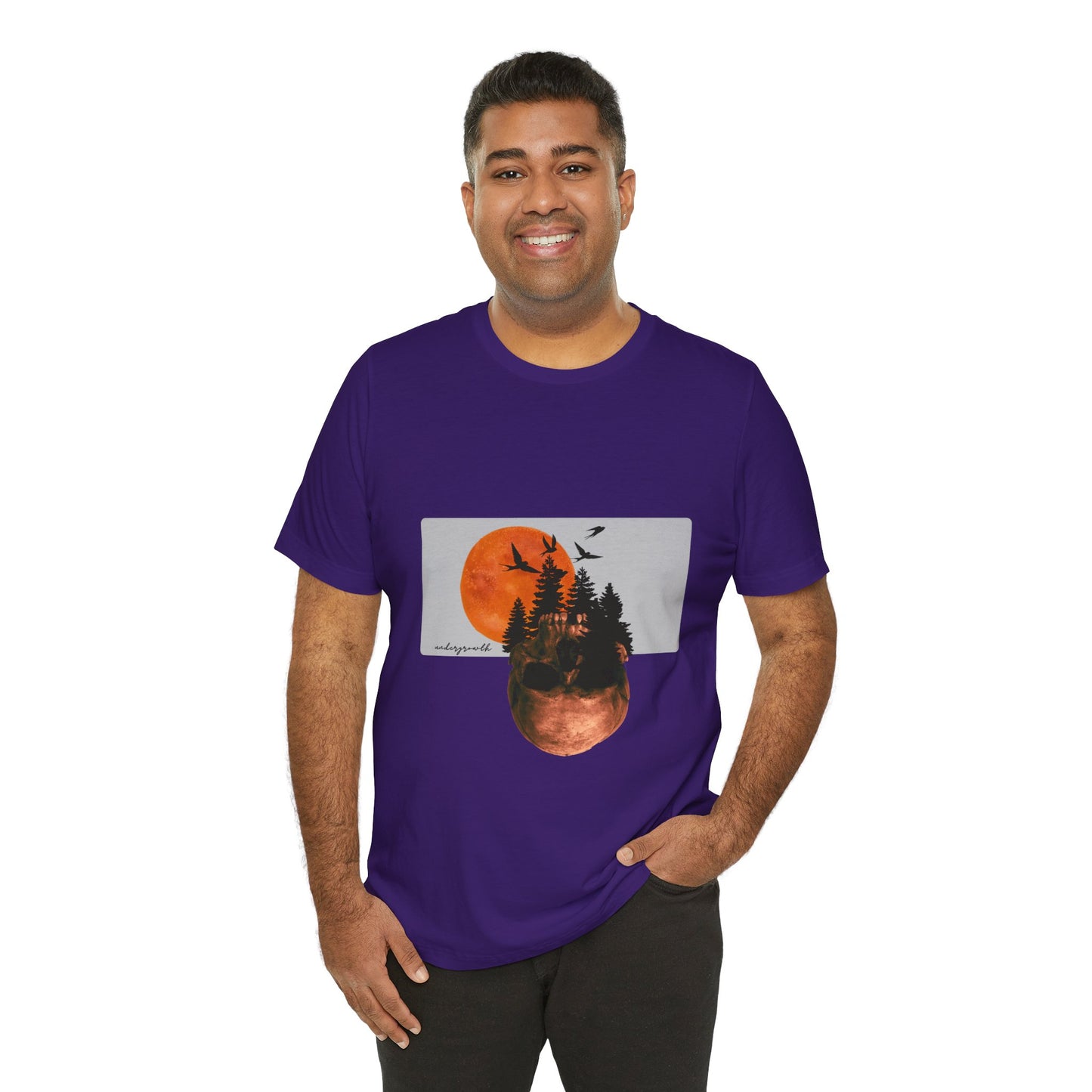 Man wearing a purple t-shirt with a nature graphic design on a white background