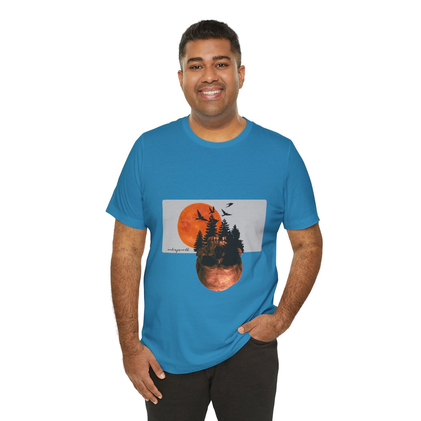 Man wearing a blue t-shirt with a nature graphic design on a white background