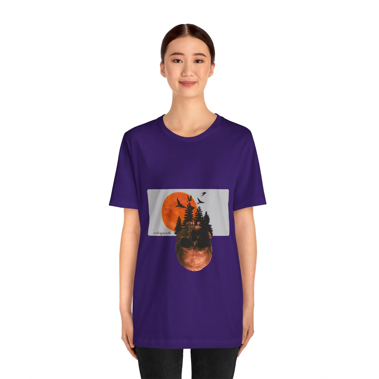 Person wearing a purple t-shirt with a graphic design on a white background