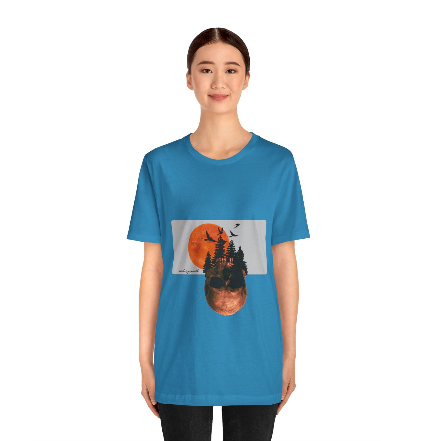 Person wearing a blue t-shirt with a graphic design on a white background