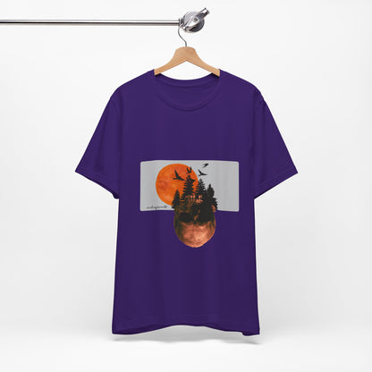 Purple t-shirt with a graphic design of trees and a sunset on a hanger against a white background