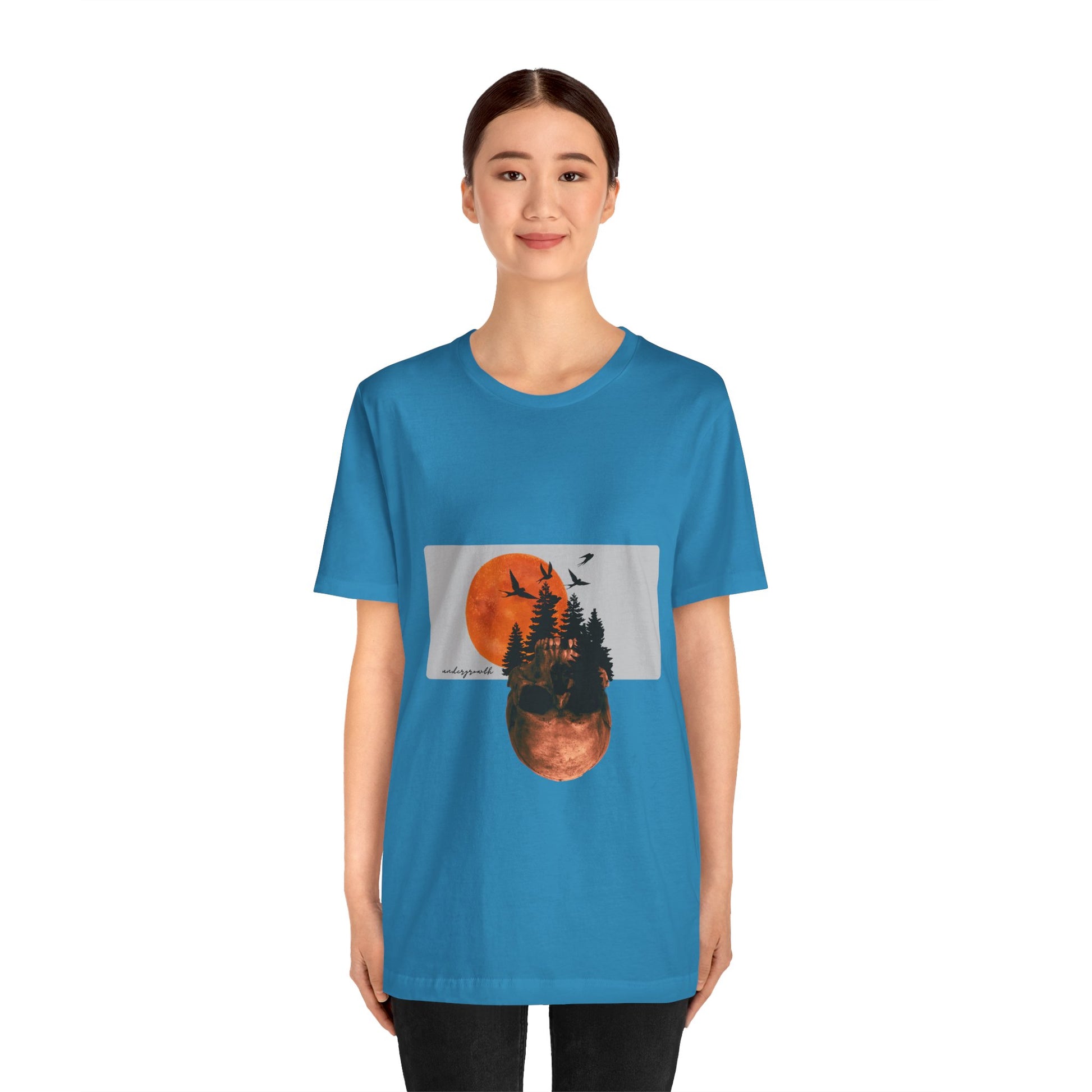 Person wearing a blue t-shirt with a graphic design on a white background